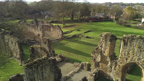 basingwerk abbey landmark medieval abandoned welsh ruins aerial view dolly close right