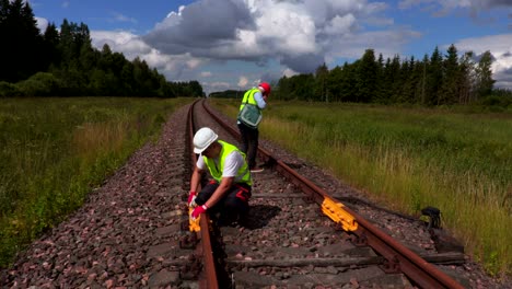 railway staff checks switches on railway track