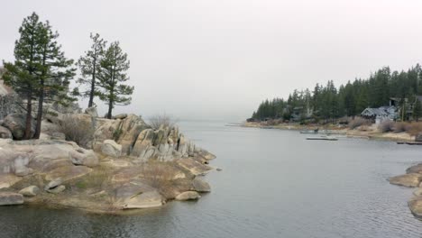 aerial 4k footage of big bear lake's shore with spooky fog