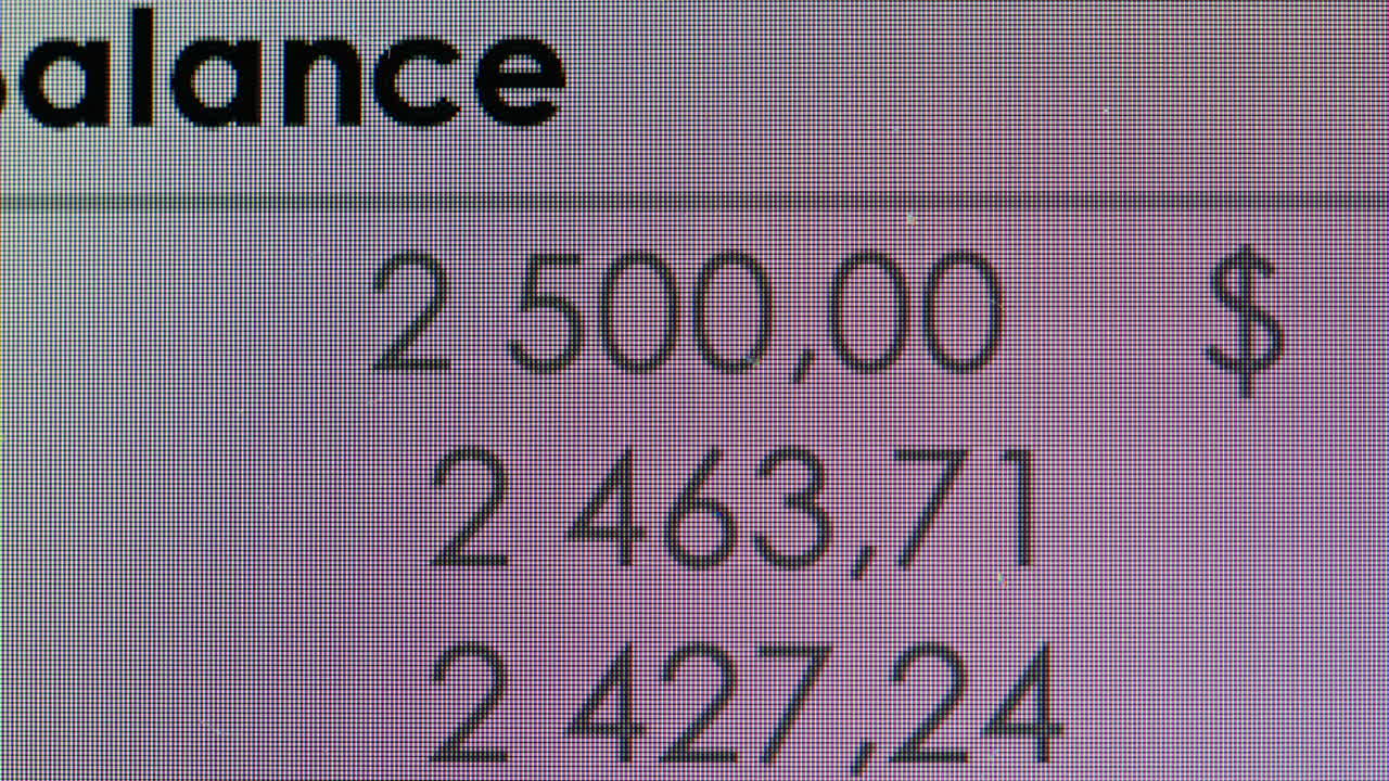 Digital Screen Displaying Scrolling Financial Numbers and Balance