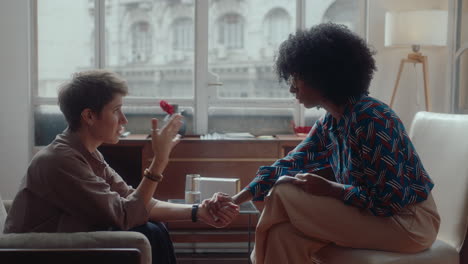 psychologist supporting upset female patient during therapy session
