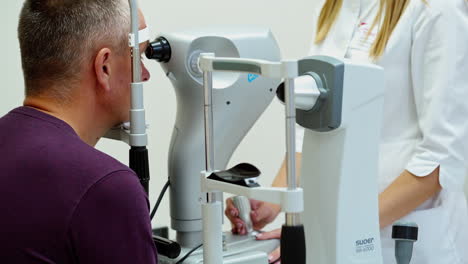 doctor and patient in ophthalmology clinic. female doctor ophthalmologist checking the eye vision in modern clinic
