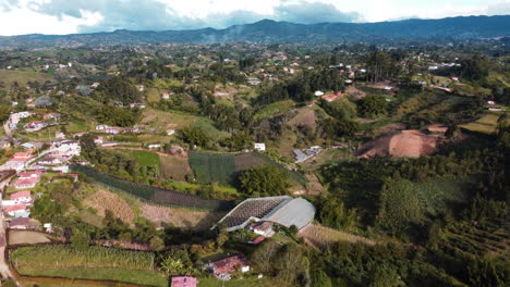 aerial perspective of the agricultural hills with field crops in rural colombia.