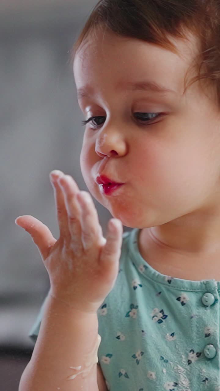A Curious Child Exploring the Wonders of Texture and Creativity with Flour on Her Hands, Capturing a Moment of Discovery and Joy in a Playful Environment
