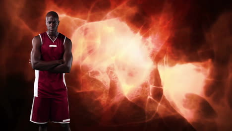 basketball player standing with arms crossed over fiery abstract animation background