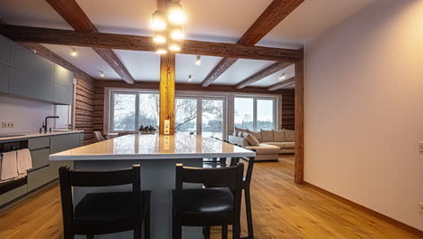 panning view of an open concept kitchen looking in to the dining area and living space