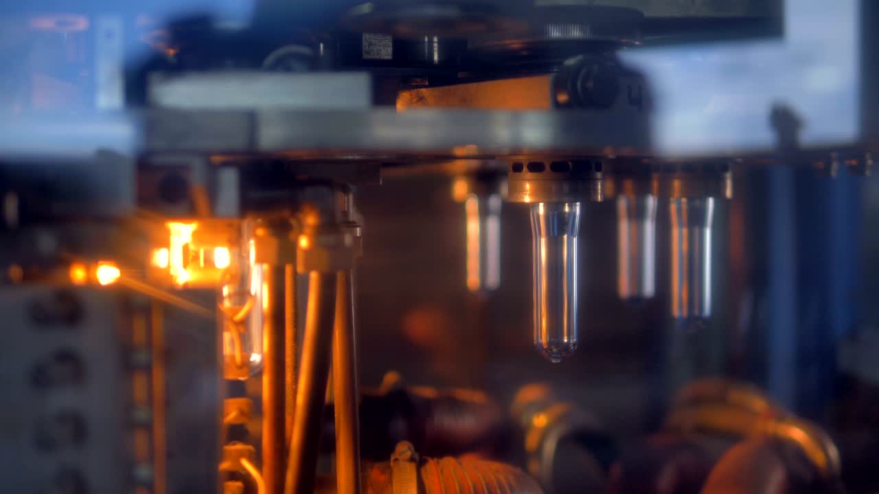 PET bottle preforms moving on rotary wheel.