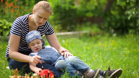 mother and son spending time on the lawn in countryside