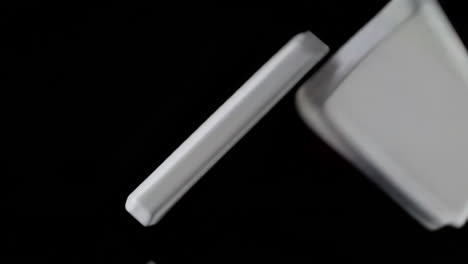 two white rectangular objects on black background