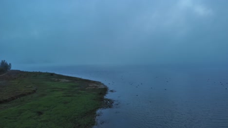 Dusk-over-Nanclares-de-Gamboa-reservoir,-tranquil-water,-serene-Basque-landscape