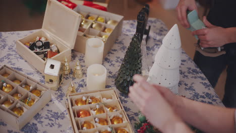 friends placing christmas decoration at home