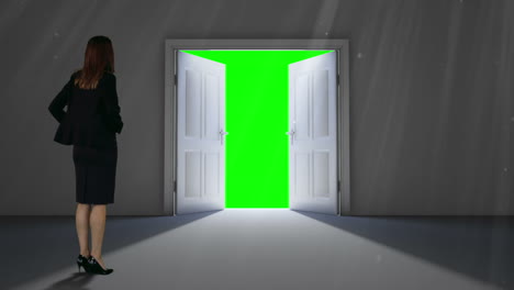 door opening to green screen watched by businesswoman