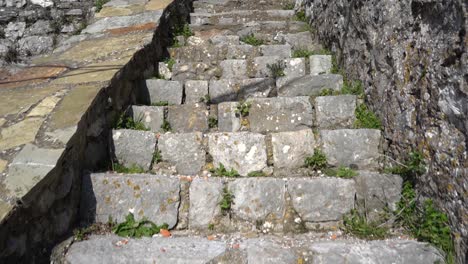 climbing stone stairs of medieval fortress, ascending slowly to heaven