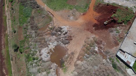 aerial view over an excavator on a redevelopment working site in kibera, largest slum in africa