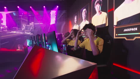 cyber sportsmen hugging and celebrating victory team of young esportsman gamers players screaming and embracing each other while celebrating victory in gaming tournament cybersport
