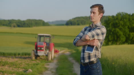 proud farmer holds digital tablet portrait shot in field