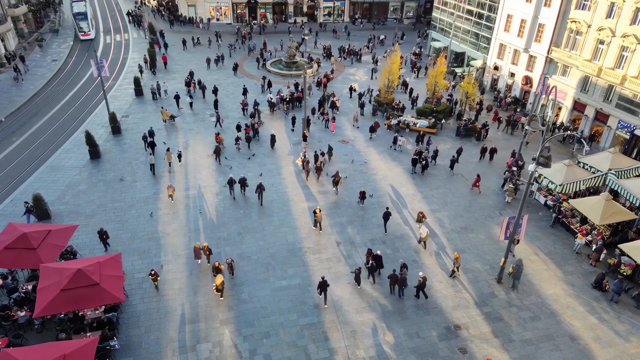 Veduta aerea di persone che camminano in una piazza affollata della città.