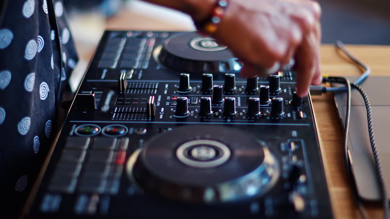 Close up of a woman touching the buttons of a DJ controller