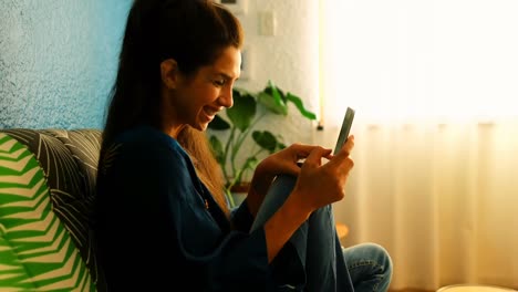 Woman-using-mobile-phone-at-home-4k