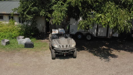 farmers unloading trailer attached to atv full boxes with fresh tomato fruits