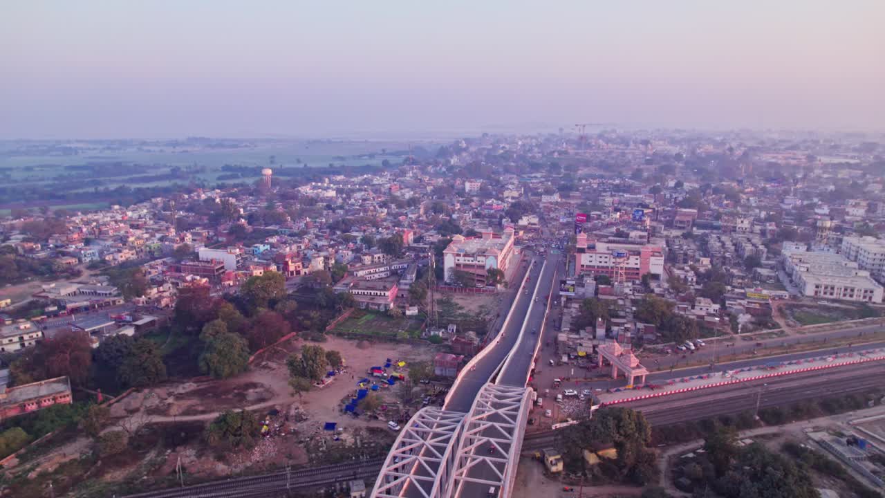 Tedhi Bazar Railway Overbridge with Shree Ramjanmbhumi Temple or SHREE RAM MANDIR with fog at day time, tilt up, drone shot, 4k.