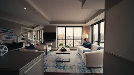 wide-push-in-shot-revealing-a-modern-cozy-living-room-setup-with-white-couches-and-chairs-surrounded-by-large-windows-letting-in-natural-sunlight