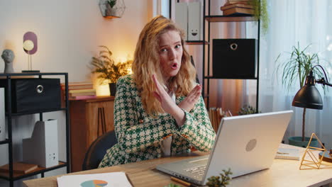 Businesswoman-employee-waves-hand-hi-gesture-greeting-welcomes-someone-at-camera-online-webinar