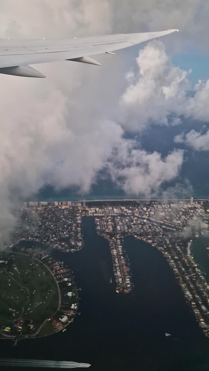 Vertical View, Flying Above Miami Beach and Clouds, Airplane Passenger Point of View, Florida USA