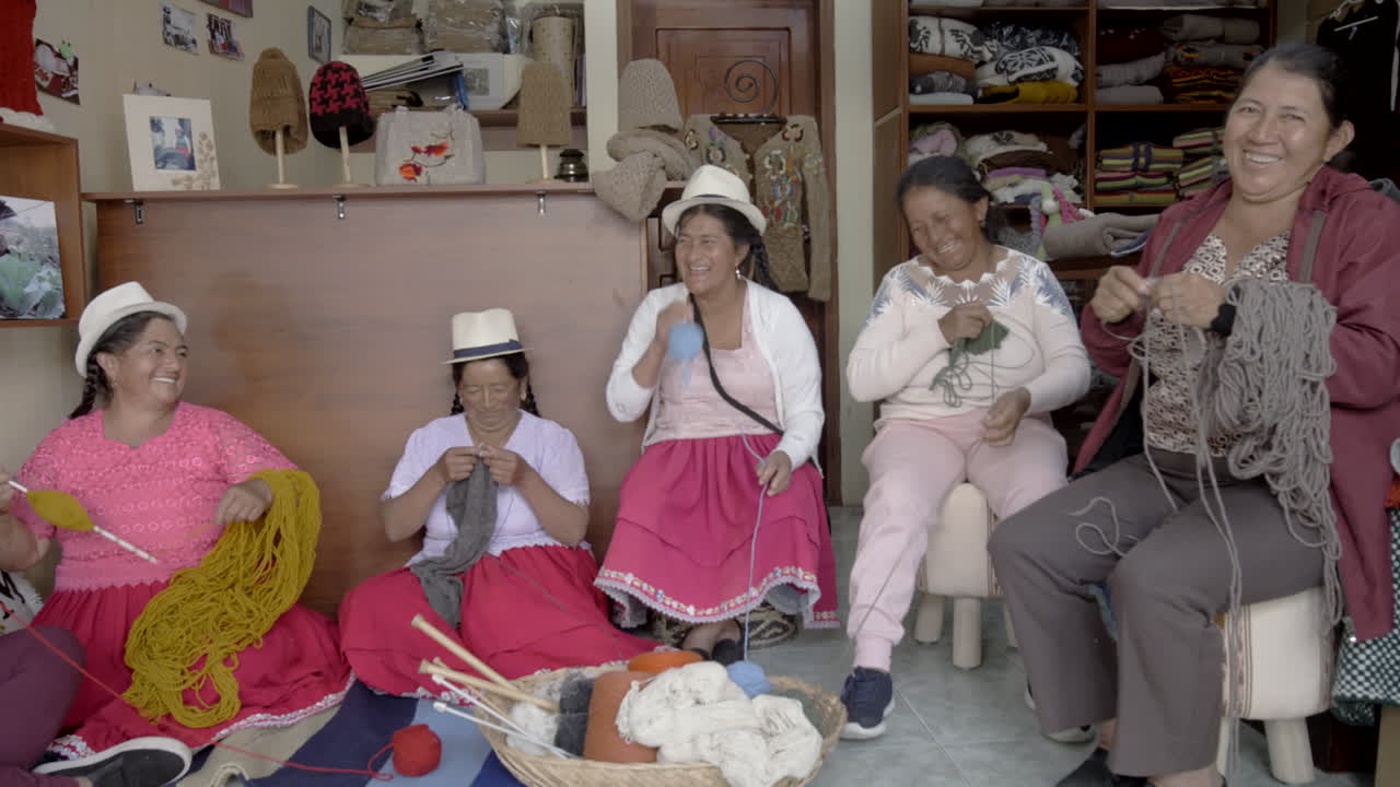 Group of indigenous women knitting and smiling