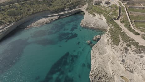 Aerial-footage-revealing-Kalanka-bay-in-Malta-on-a-clear-day