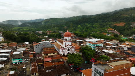 Aerial-view-around-the-St-Raphael's-Church-in-cloudy-San-Rafael,-Antioquia,-Colombia