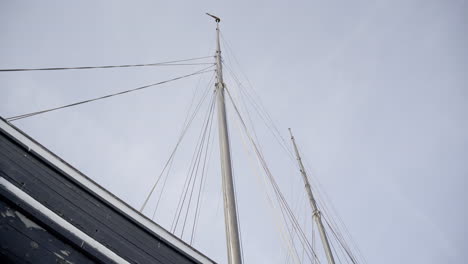 close-up old dark sailboat with sails not out 4k