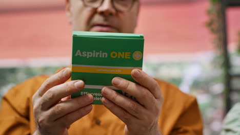 Senior-couple-looking-at-pills-and-vitamins-in-boxes-and-bottles