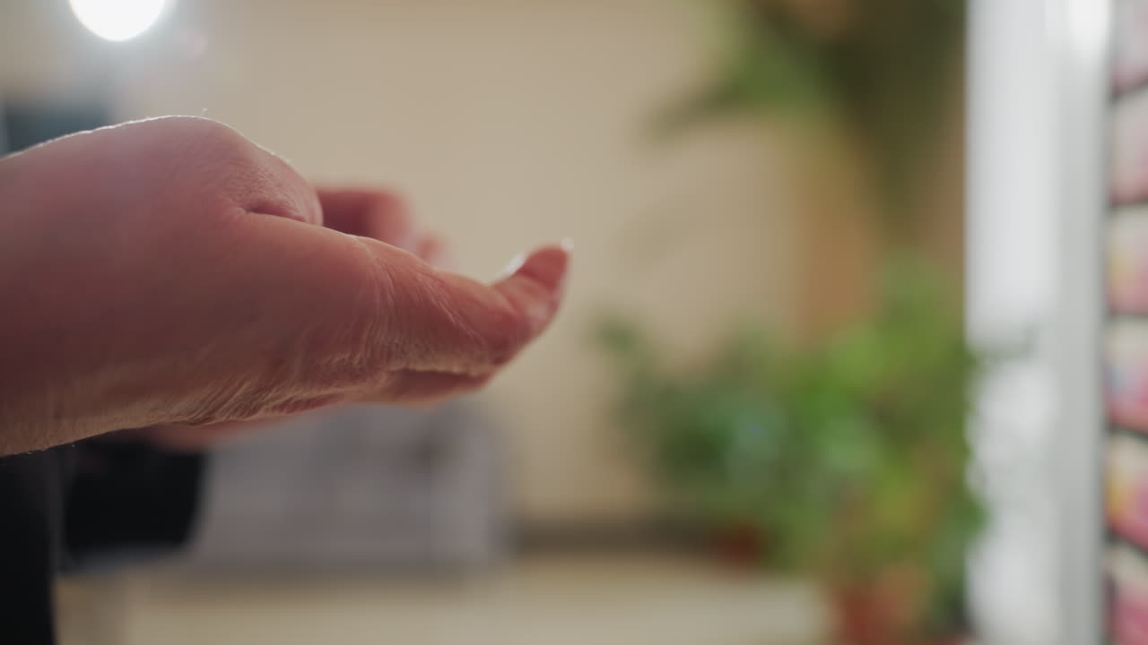 Close-up view of businessperson hand holding coins with care and precision dressed in formal suit showing focus professionalism and mindfulness with blurred office background