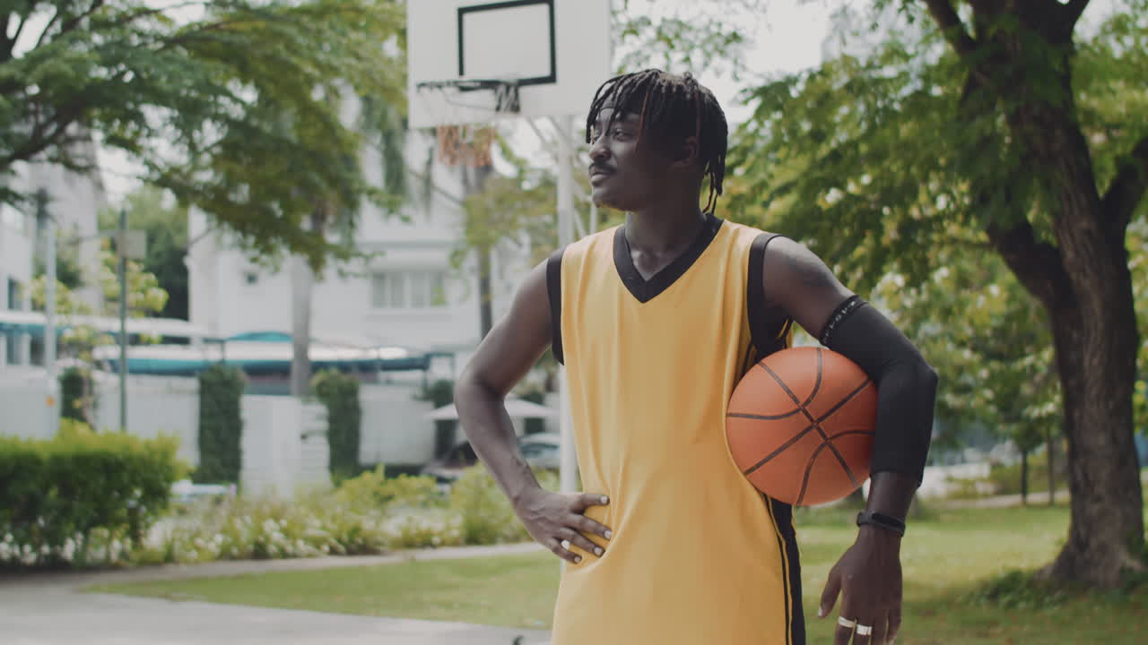 Black Streetball Player Posing for Camera on Playground