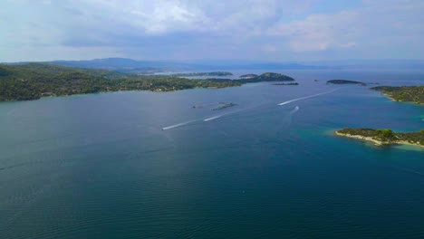 steady drone clip over a bay with crystal water and exotic islands in vourvourou, halkidiki, northern greece in 4k