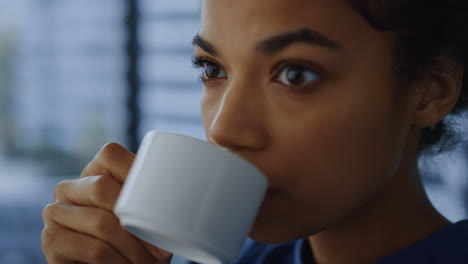 business woman drinking coffee during break in office. employee enjoying drink