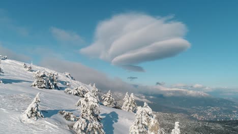 snowy mountain peaks with unusual clouds