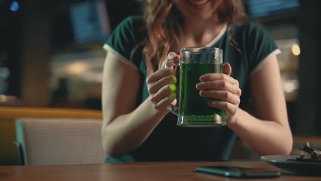 Green beer mug. Close-up. Celebrating Saint Patrick&#039;s Day in a pub.
