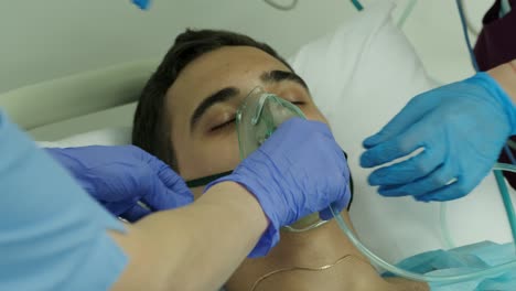 nurses wear an oxygen mask to a patient in intensive care 1