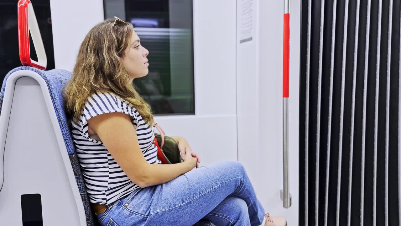Female Passenger Sitting On Public Transport Seat Looking Forward