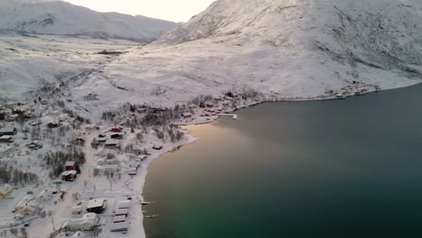 aerial panning shot of the small lake front village of ersfjordvegen in norway