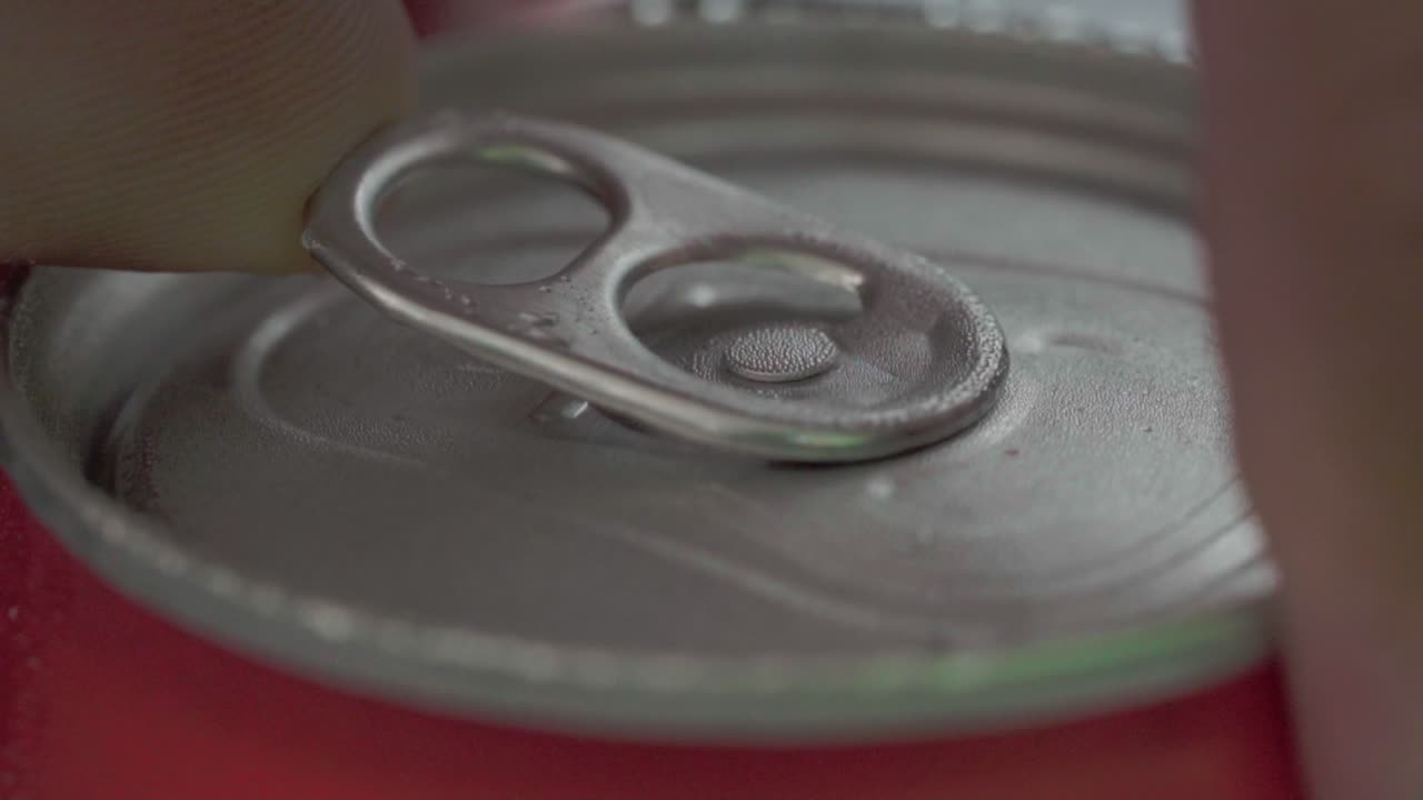 Person opening a soda can. Slow motion macro close-up