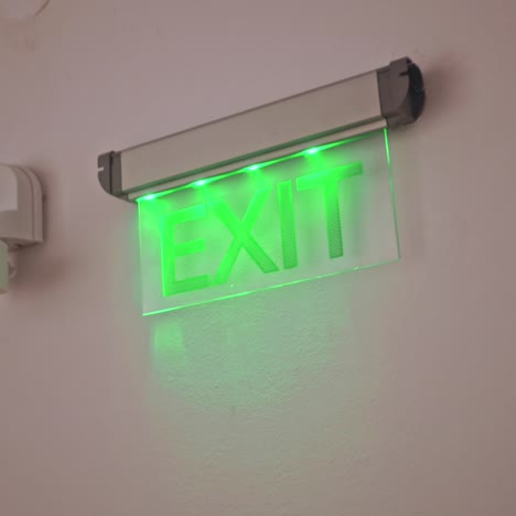 exit sign points the way out of building