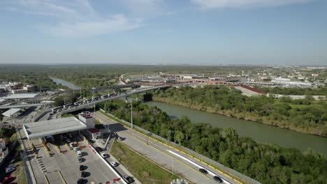 AERIAL---International-Bridge-over-Rio-Grande,-United-States-Mexico-border,-forward