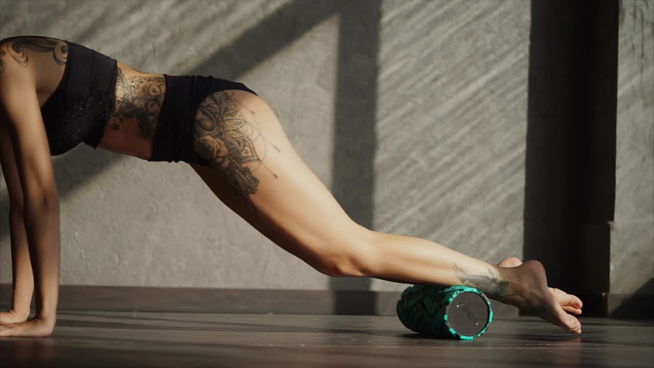 Woman Stretching with Foam Roller