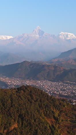 portrait drone shot tilting toward the towering dhaulagiri mountain, in nepal
