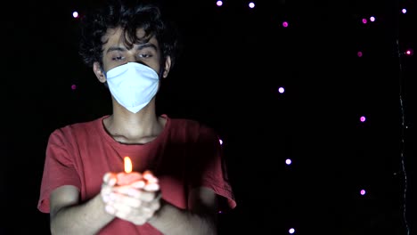 young man celebrating diwali festival with medical mask