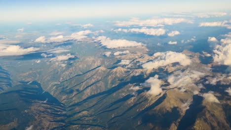 Beautiful-mountain-range-covered-by-cumulus-clouds-Pov