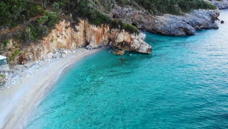 Sandy-beach-with-rock-cave-filmed-in-the-evening-light